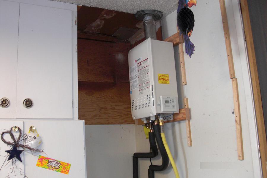 Picture of Tankless water heaters help save valuable storage space. - Water Heaters Masters Inc.