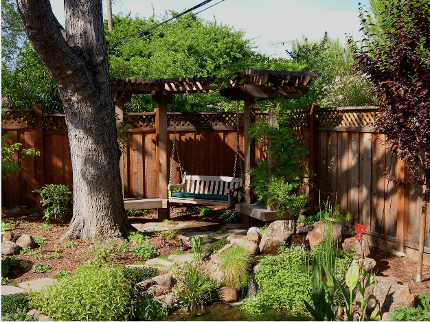 Picture of This landscape features a swing and benches by a pond. - Confidence Landscaping, Inc.