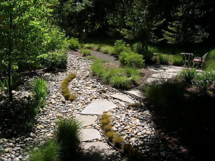 Picture of Gardens of the Wine Country created this dry creek bed with stepping stones to add to the naturalization of a client's property. - Gardens of the Wine Country Inc.