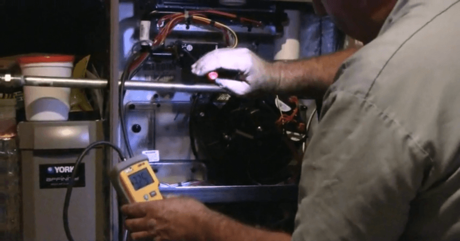 Picture of A Moore Mechanical technician performs a test on an HVAC system. - Moore Mechanical Heating & Air Conditioning