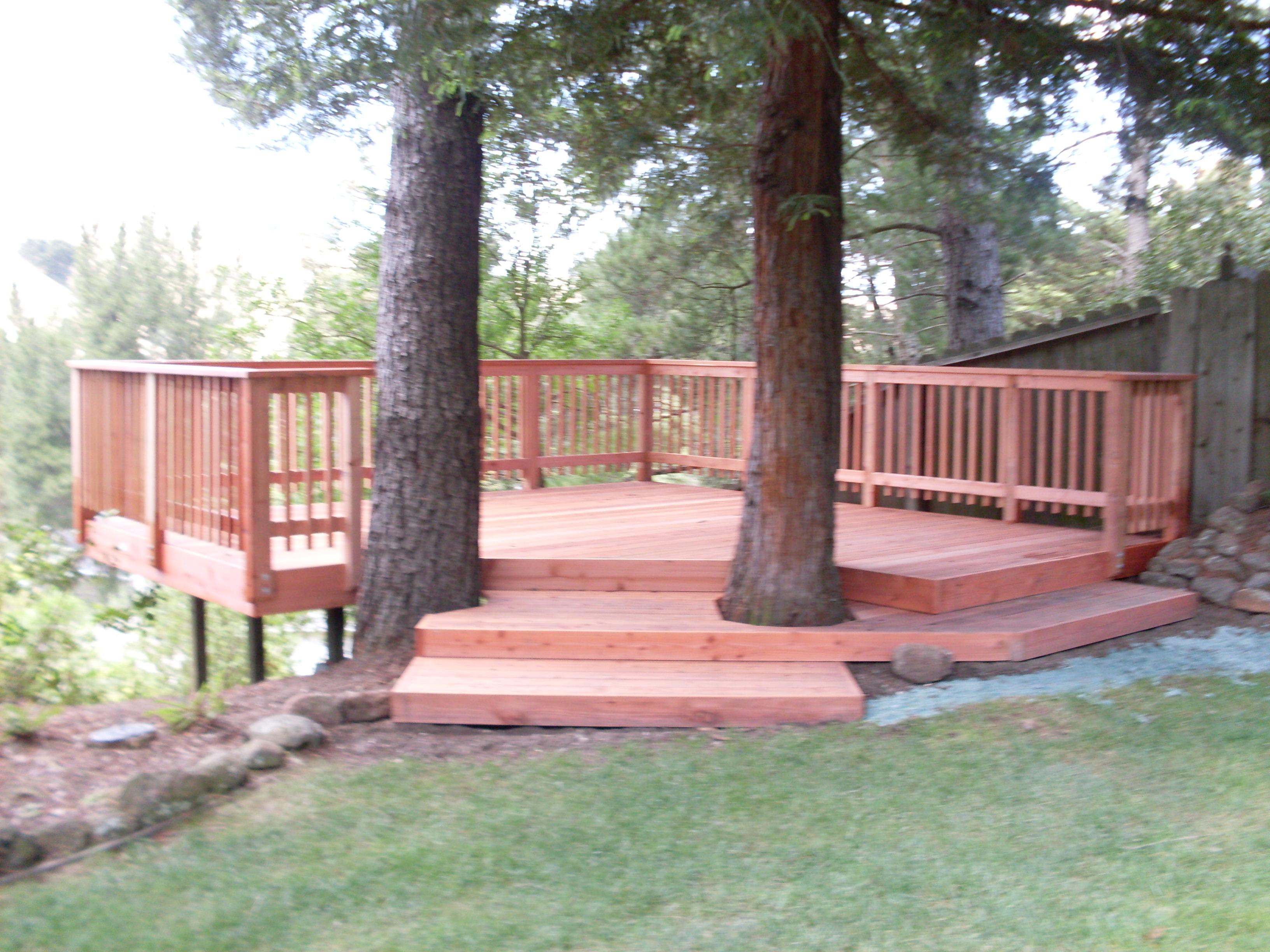 Picture of A & J Fencing built this elevated redwood deck around the client's trees. - A and J Fencing