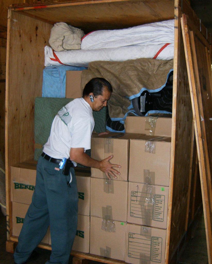 Picture of An A and P Moving technician loads inventory into a storage container. - A and P Moving, Inc.