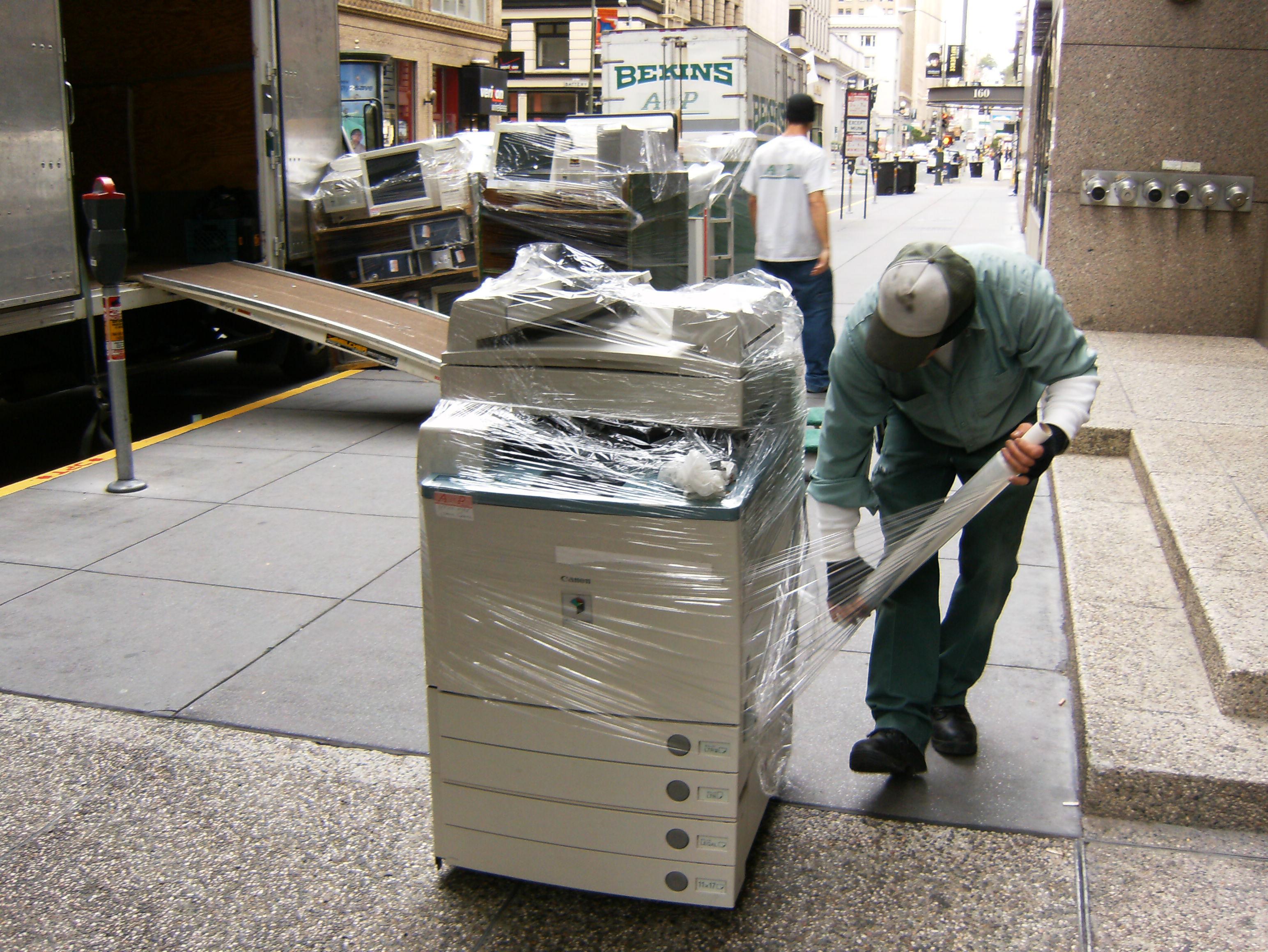 Picture of An A and P Moving technician prepares a copier to be moved. - A and P Moving, Inc.