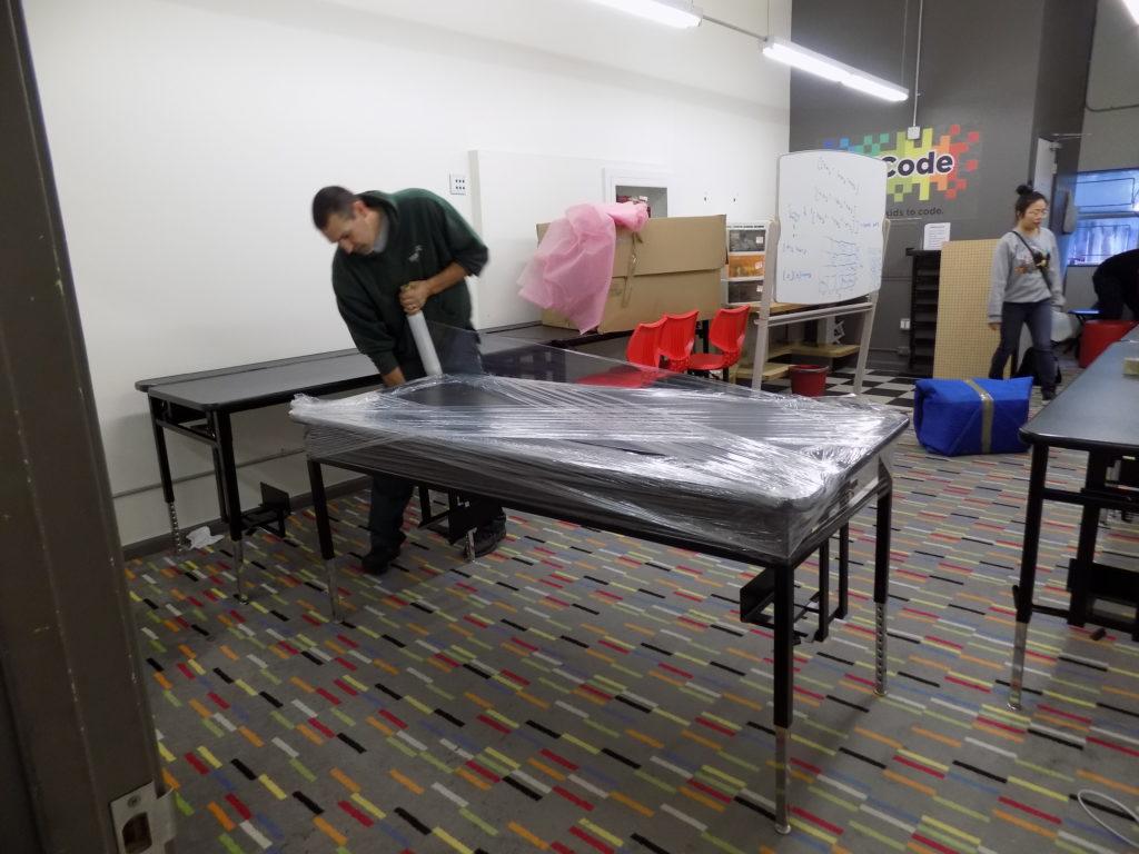 Picture of An A and P Moving technician prepares office furniture to be moved. - A and P Moving, Inc.