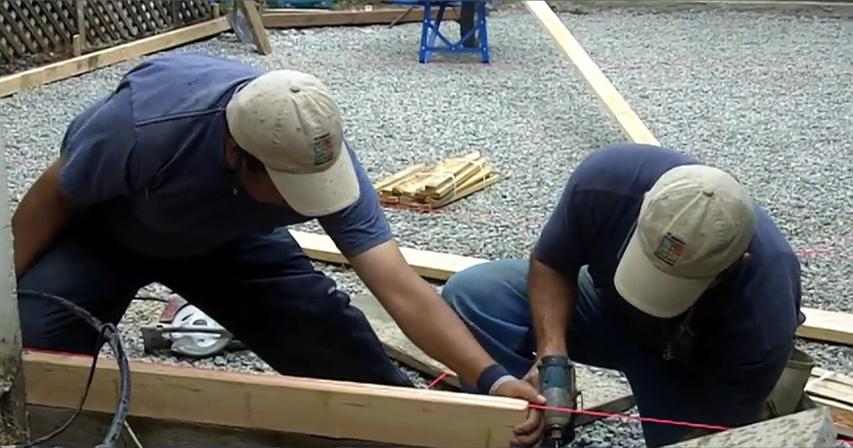 Picture of Two All Seasons Construction technicians work on a foundation project. - All Seasons Construction