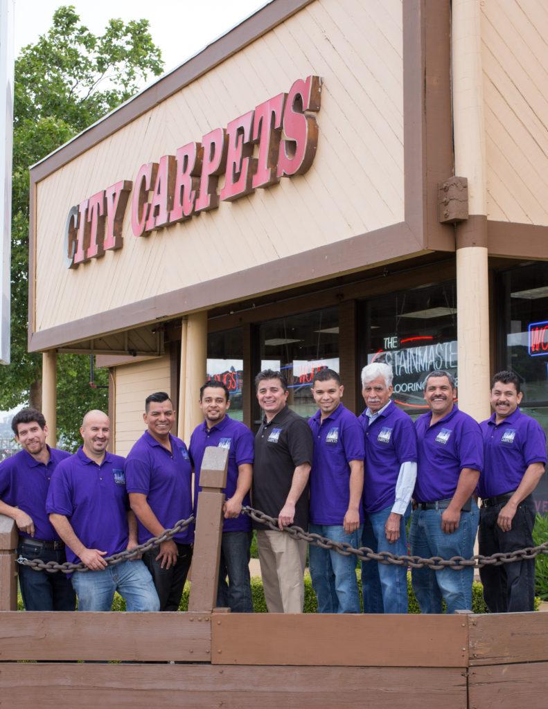 Picture of City Carpets' staff members educate customers about their flooring choices. - City Carpets