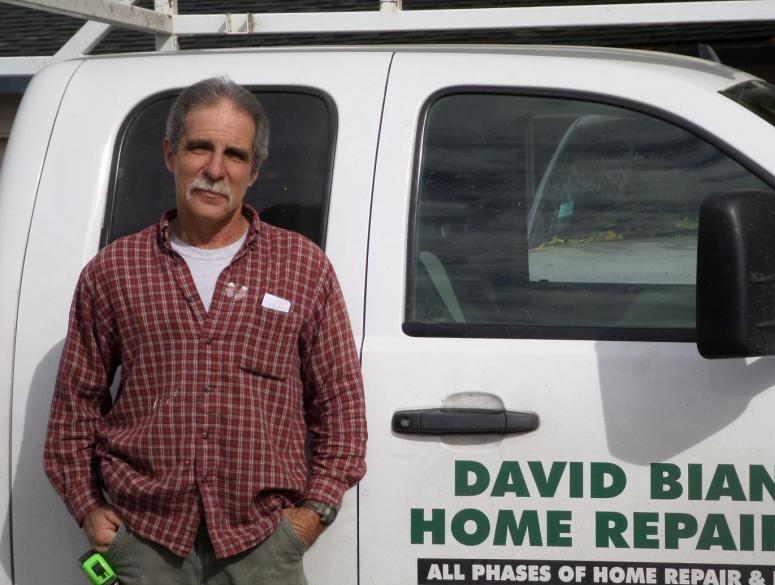 Picture of President David Bianchi stands next to one of his service vehicles. - David Bianchi Home Repair, Inc.