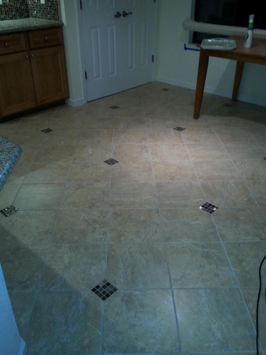 Picture of Devengenzo Landscaping & General Engineering installed this porcelain kitchen floor tile with a diamond-shaped decorative inset. - Devengenzo Landscaping & General Engineering Inc.