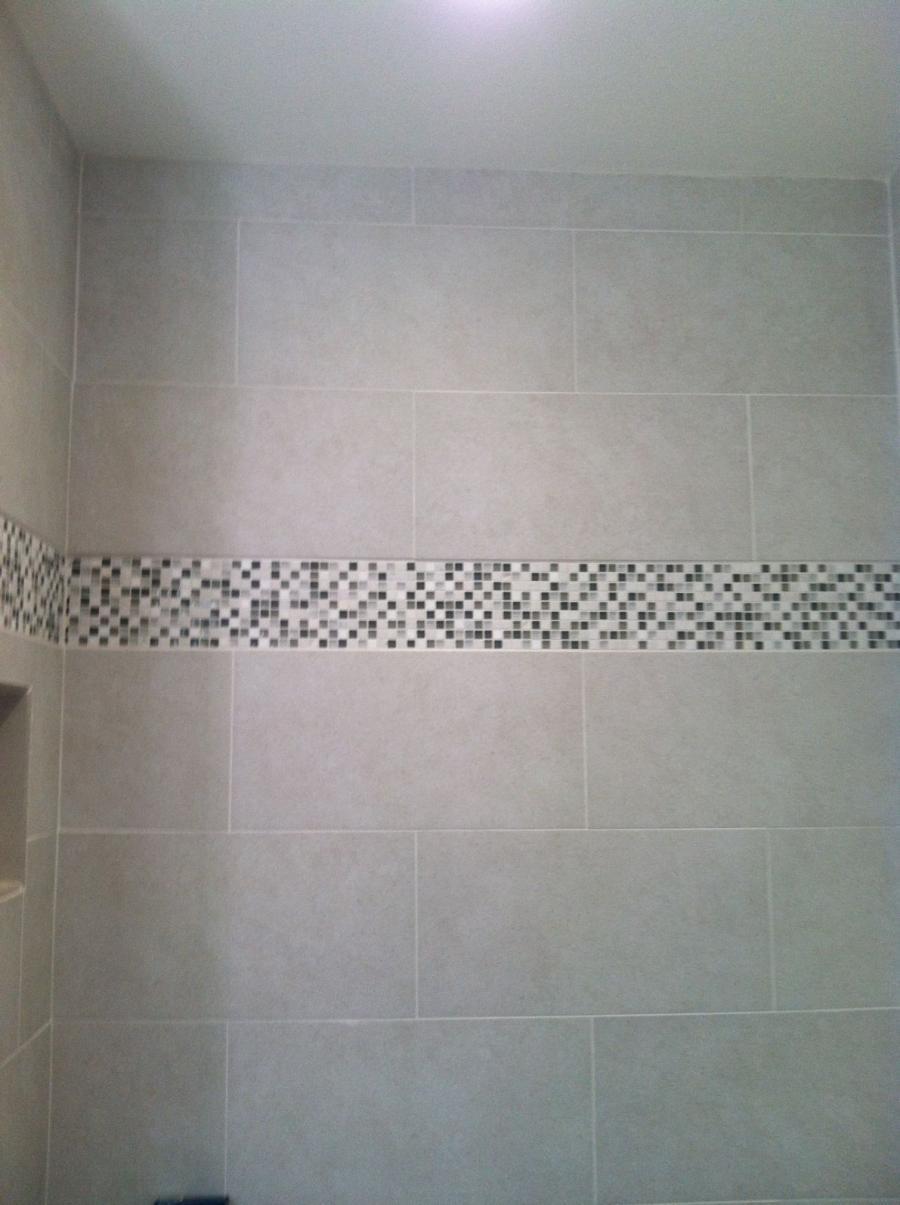 Picture of This floor-to-ceiling shower features mosaic accent tiles and grey porcelain tiles that add visual texture and warmth. - Devengenzo Landscaping & General Engineering Inc.