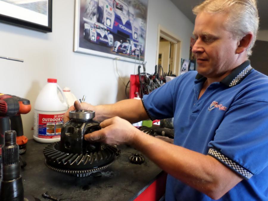 Picture of Owner David Proffer works on a component of a customer's car. - Empire Sports West