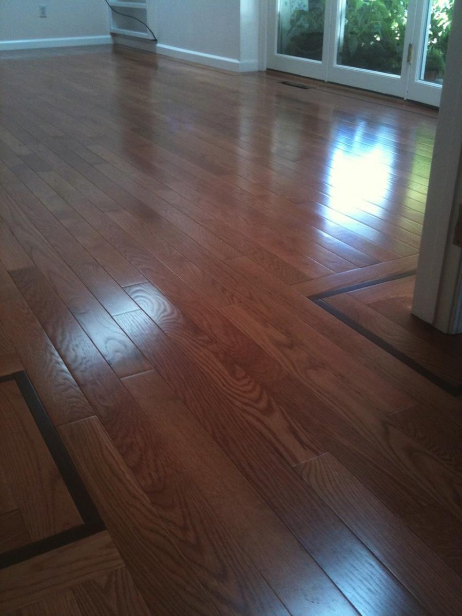 Picture of Oak floors with walnut border and satin aluminum oxide finish. - Labourdette Construction