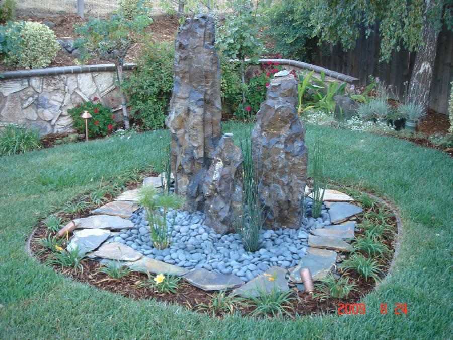 Picture of This water fountain is comprised of three natural stones and a concrete pool that contains 300 gallons of water. - Pacific Landscaping