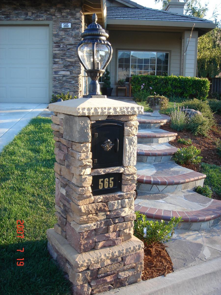 Picture of A mailbox with a light on the top covered with culture stone - Pacific Landscaping
