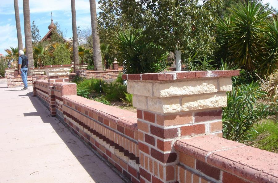 Picture of This decorative fence-wall is made from a combination of concrete brick and natural stone. - Pacific Landscaping