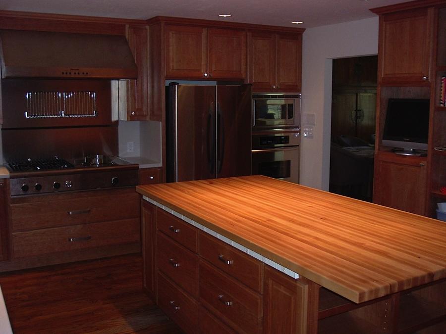 Picture of Custom cherry cabinets and maple counters with recessed lights. - Labourdette Construction
