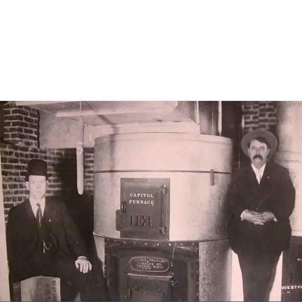 Picture of George W. (L) and George P. Schmitt second- and third-generation proprietors of Schmitt Heating Company - Schmitt Heating Company, Inc.