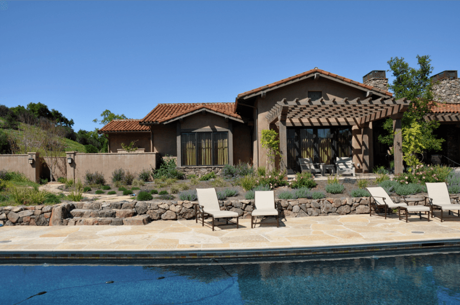 Picture of Complimentary pool plaster flagstone decking and dry stack stone walls blend with the natural colors of this Carmel home. - Jerry Allison Landscaping, Inc.