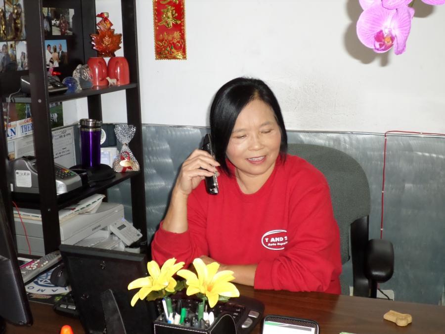Picture of Theresa speaks with a customer on the phone. - T & S Auto Repair