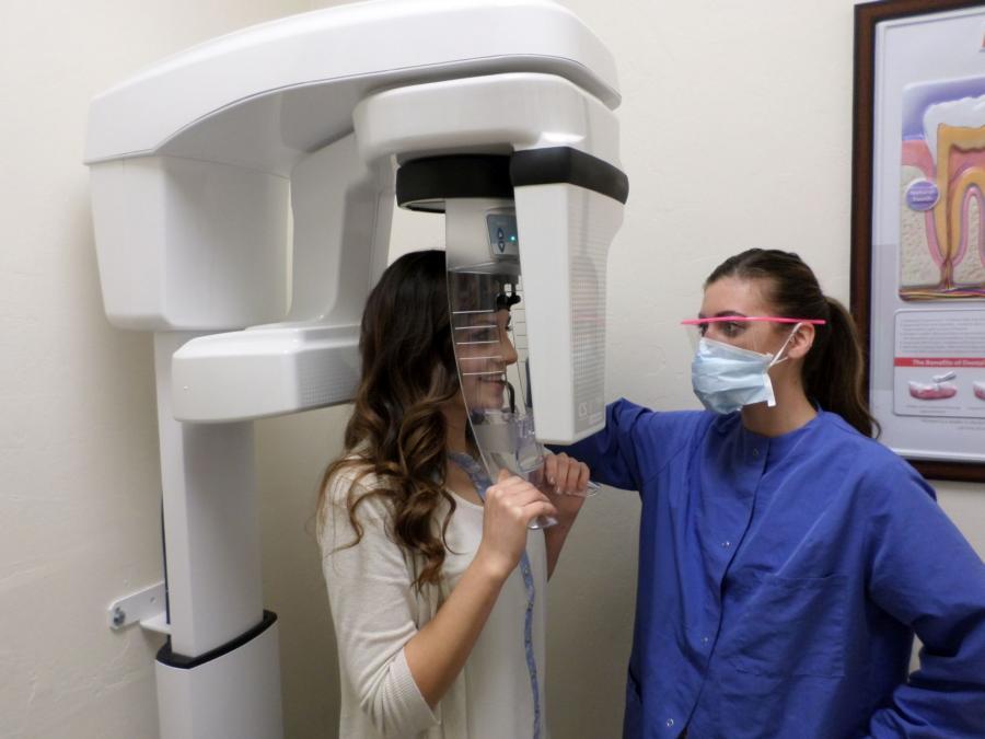 Picture of One of Dr. Hummer's dental assistants takes a panographic x-ray on a patient. - William R. Hummer, DDS
