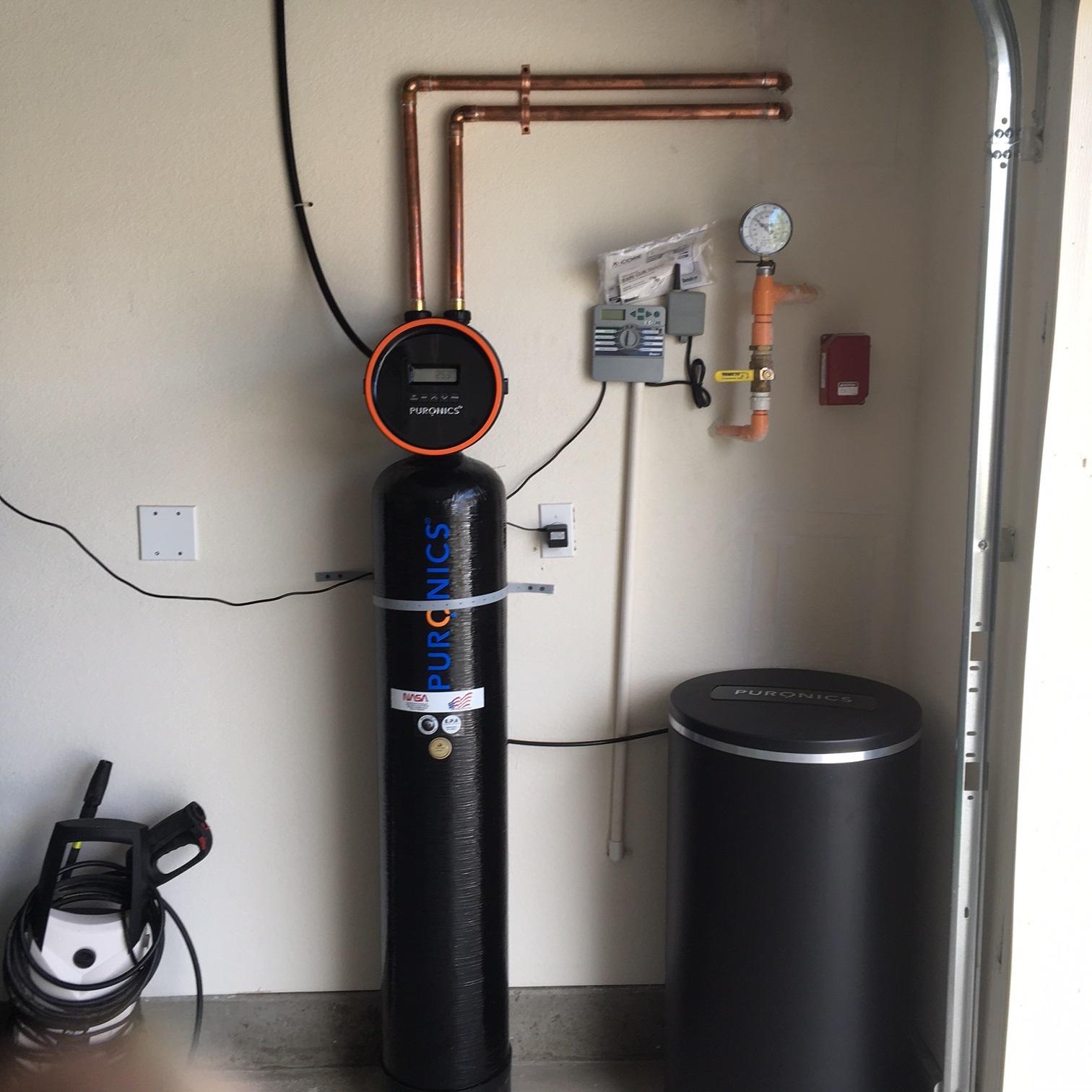 Picture of This Defender® whole-house water treatment system features a fiberglass tank and is designed to remove the taste and odor of chlorine inhibit the growth of bacteria and soften the water. - Puronics, LLC