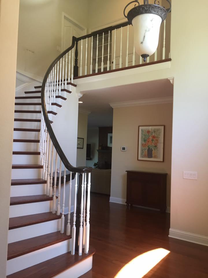 Picture of This traditional curved staircase features stained solid wood treads and railing contrasting white tread risers and turned white balusters. - Martinez Stair Company Inc.