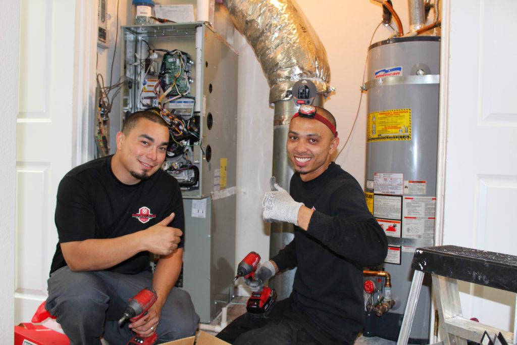 Picture of Lead Install Technicians David Mendoza (L) and Gilbert Caceres install a new HVAC system in Blackhawk. - Perfect Star Heating and Air Conditioning