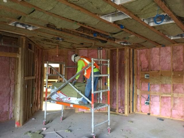 Picture of An Alcal Specialty Contracting employee installs insulation in a new residential home. - Alcal Specialty Contracting, Inc.