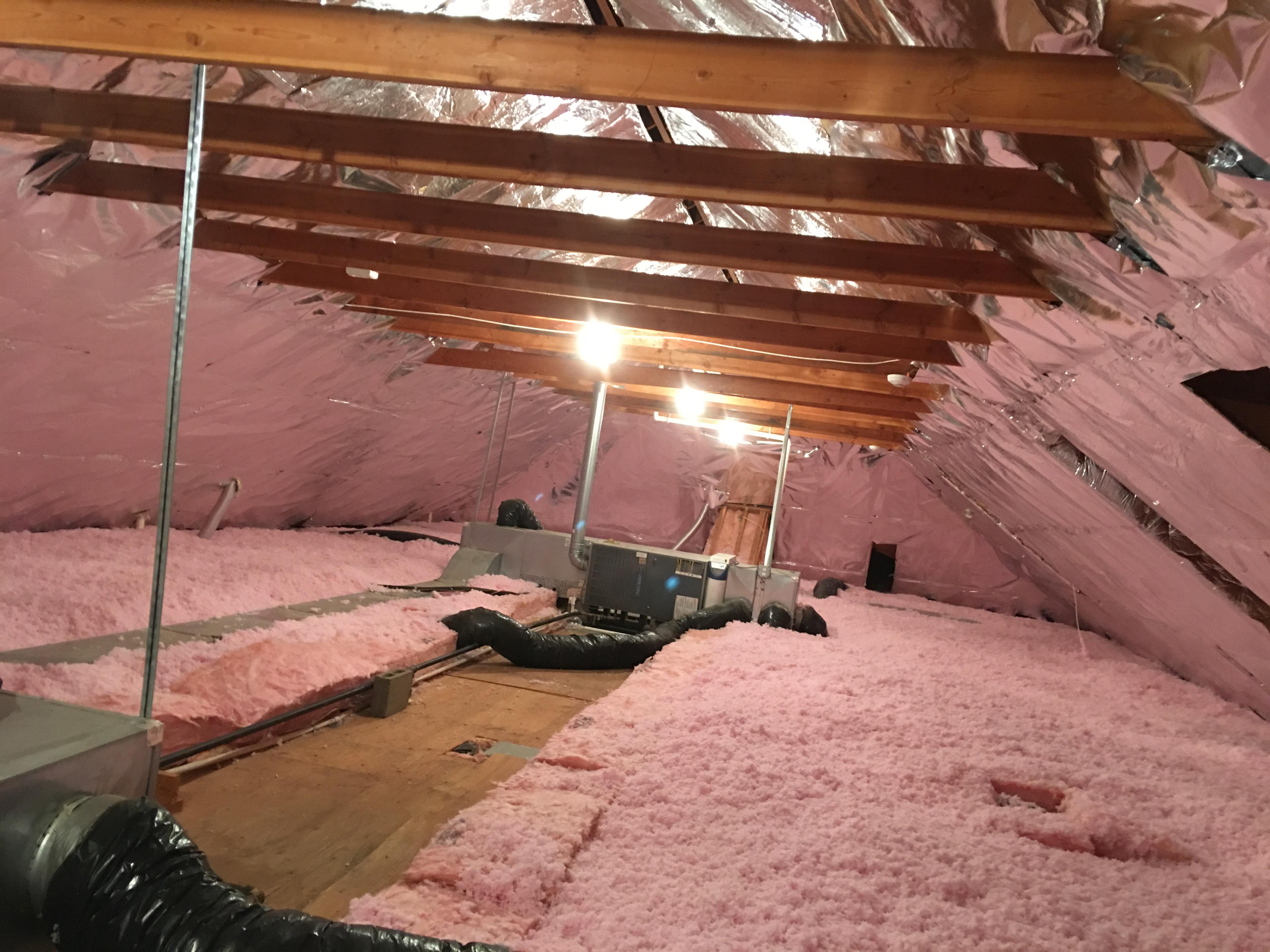 Picture of Atticare installed insulation and a radiant barrier in this attic. - Atticare Construction