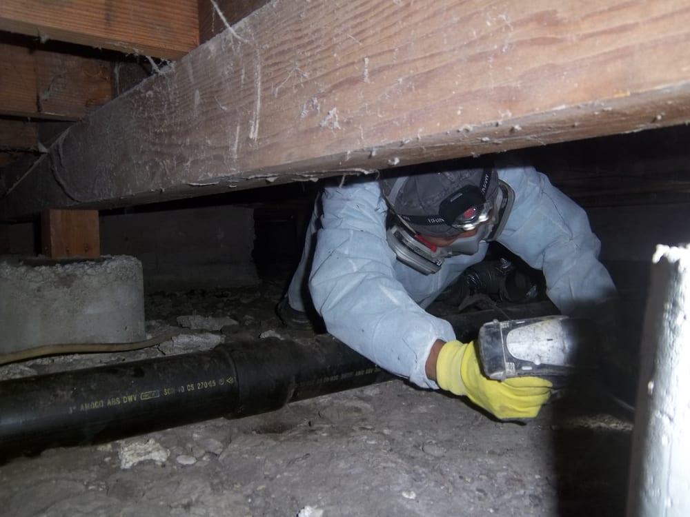 Picture of An Atticare technician fixes damage in a customer's crawl space. - Atticare Construction