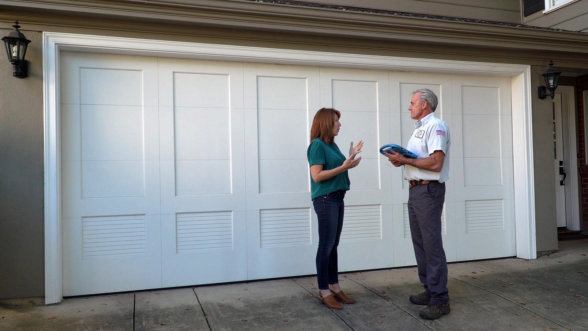 Picture of A Precision Door Services of the Bay Area technician talks to a customer about her garage door project. - Precision Door Services of the Bay Area