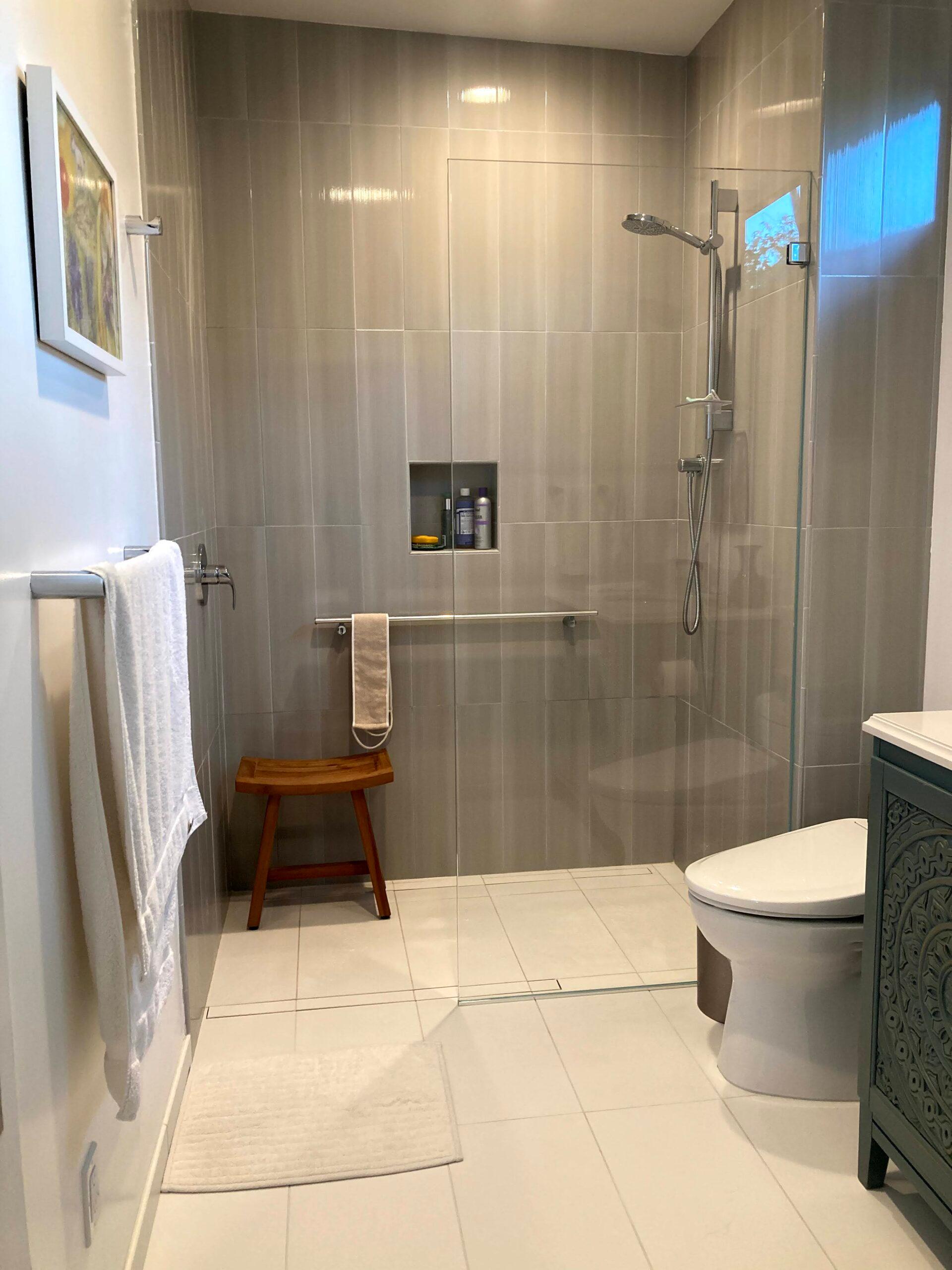 Picture of Green Living Builders installed this glass shower door to maximize the visual appearance of the small bathroom space. - Green Living Builders LLC