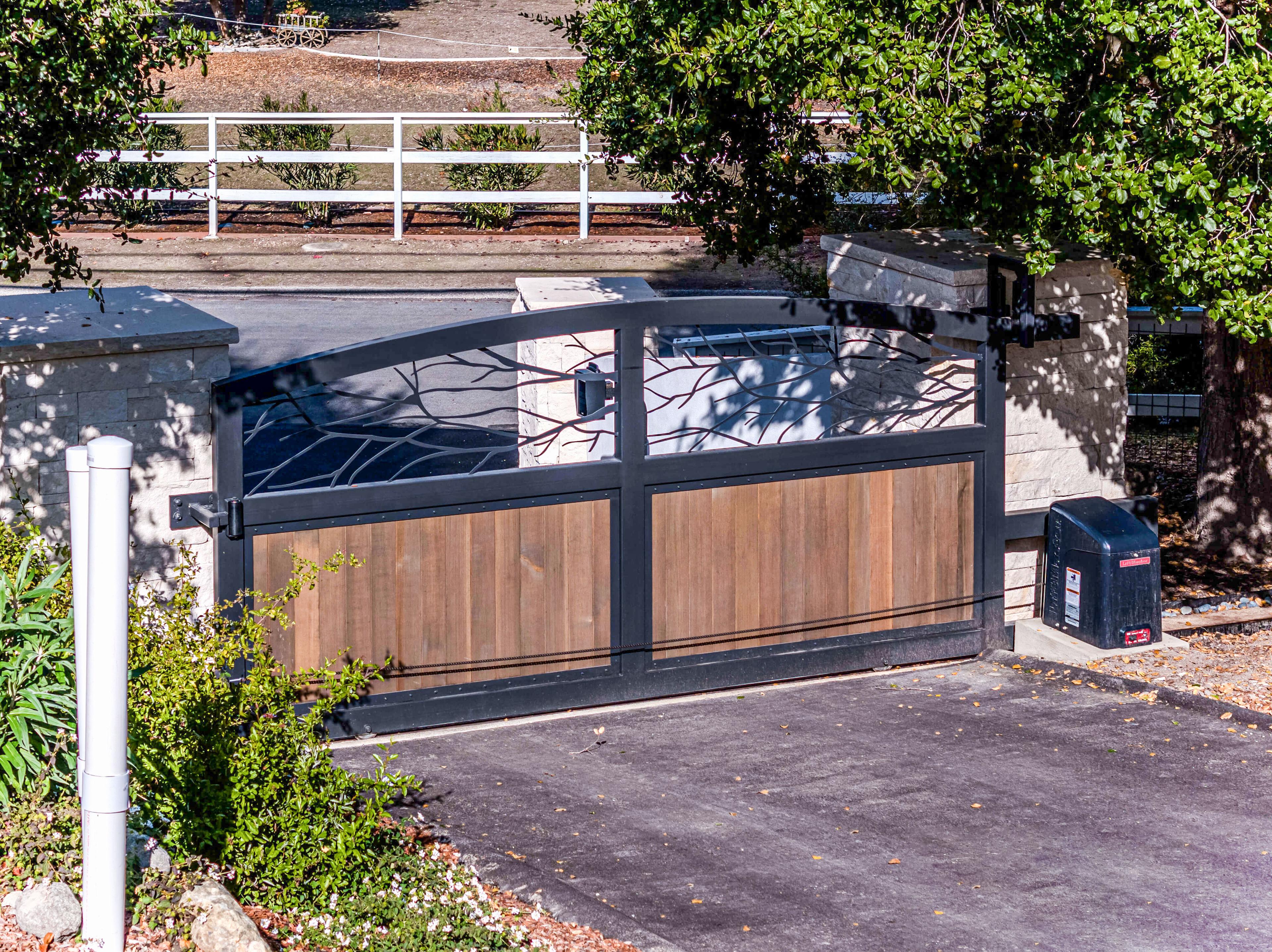 Picture of Automatic Gate Masters & Garage Doors installed this custom sliding driveway gate with a laser-cut print design in Los Altos Hills. - Automatic Gate Masters & Garage Doors, Inc.