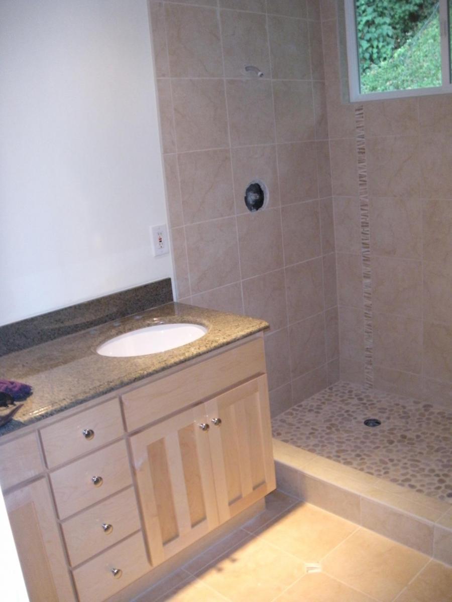 Picture of DC Tile and Stone added a pebble tile floor and a vertical accent strip to this master shower. - DC Tile and Stone