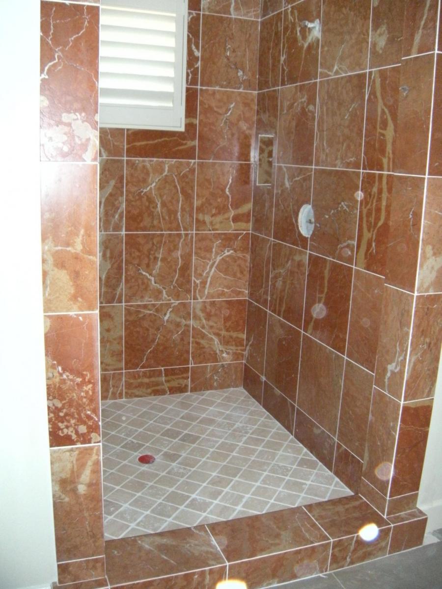Picture of This guest shower features red marble tile and a 2x2 porcelain floor. - DC Tile and Stone