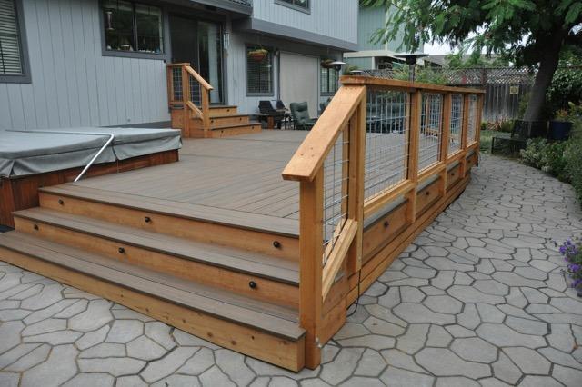 Picture of This Trex decking features redwood and hog wire railings and accent lighting. - Farrar Construction Inc.