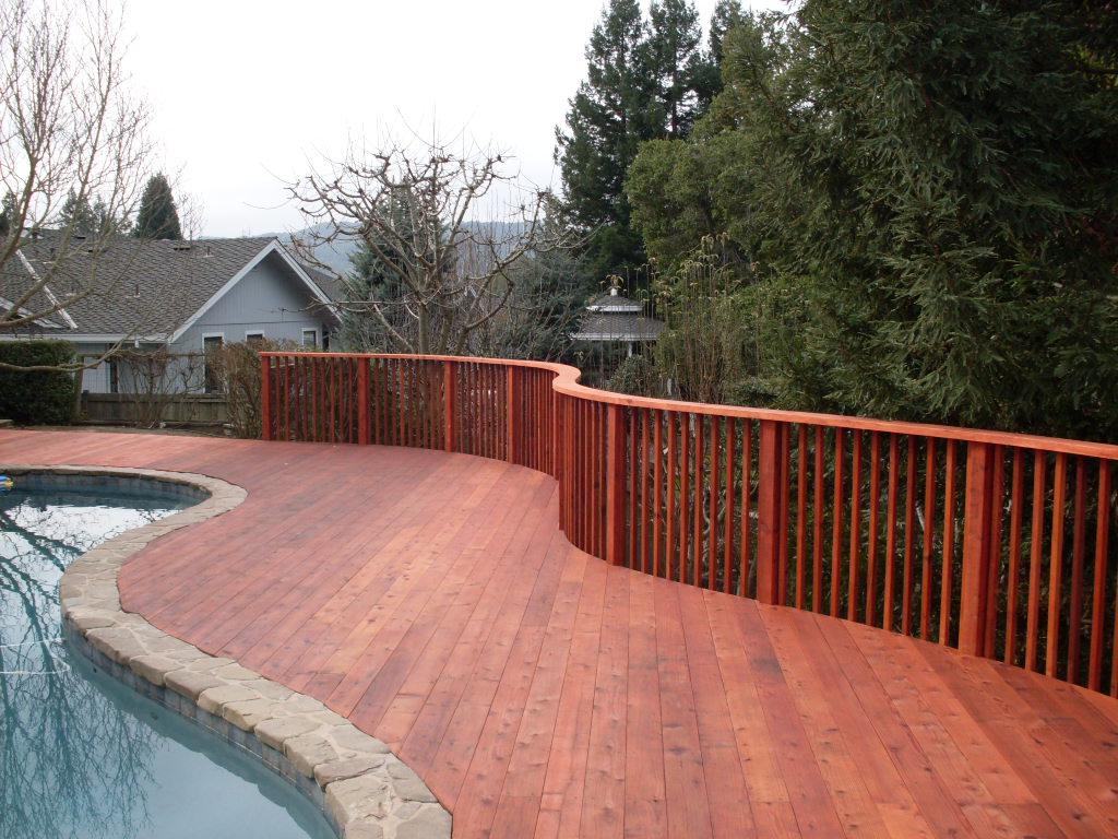 Picture of This redwood deck features a curved picket railing. - A and J Fencing