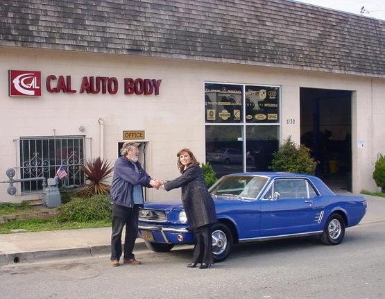 Picture of Owner Nana Sarkisian (R) stands with a customer outside Cal Auto Body's Colma shop. - Cal Auto Body