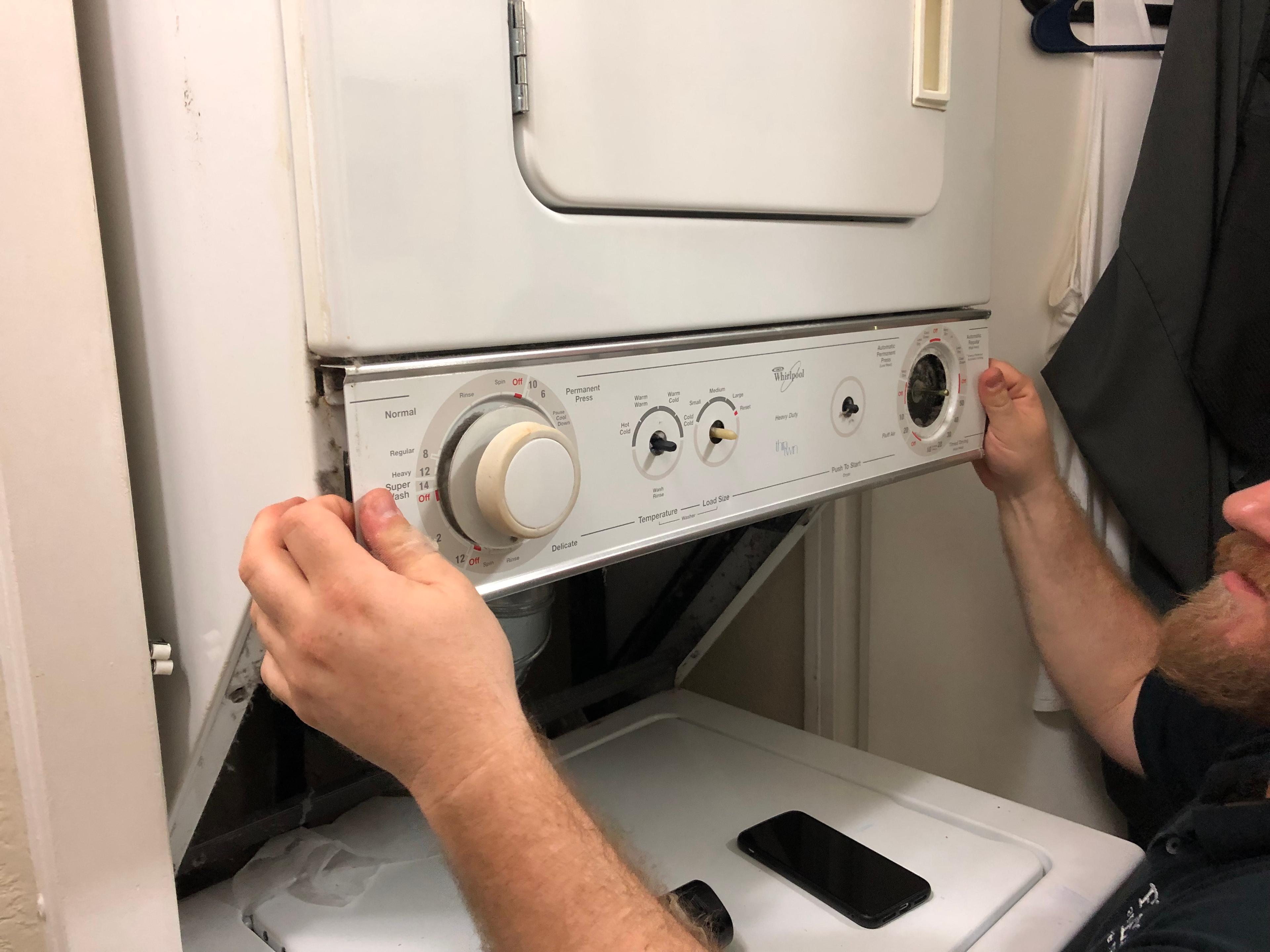 Picture of A FixEm Appliance Repair technician diagnoses a stacked combo washer and dryer. - FixEm Appliance Repair
