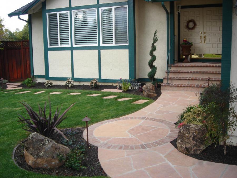 Picture of A front yard with a walkway landing area that's covered with flagstone and surrounded by grass and plants - Pacific Landscaping