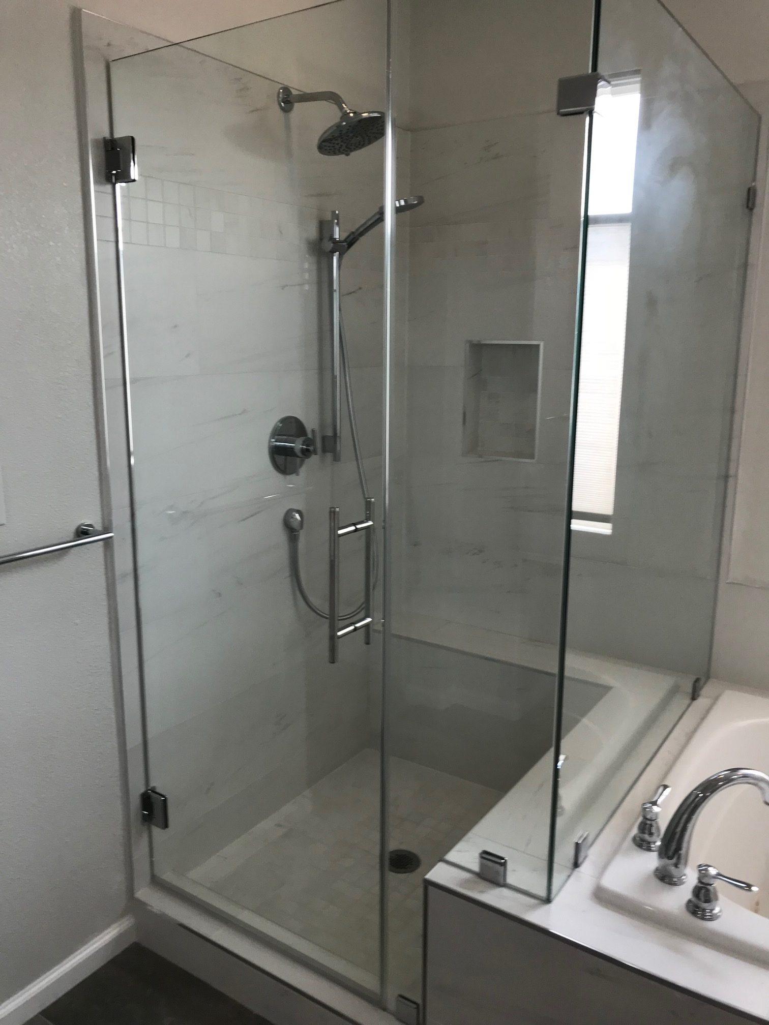 Picture of LW Construction & Handyman Services installed this tile shower which features a frameless glass enclosure and Grohe water fixtures. - LW Construction & Handyman Services
