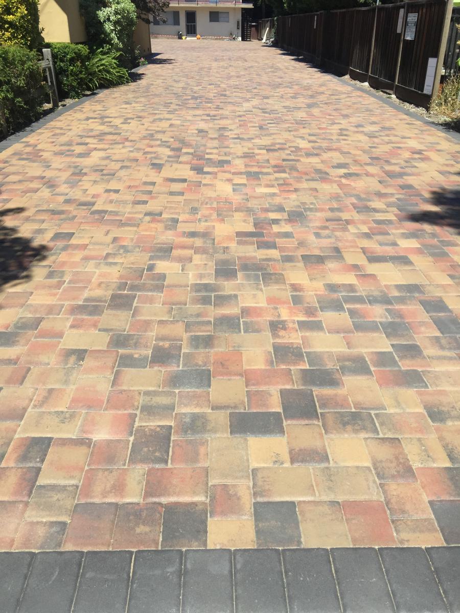 Picture of Atlas Pavers installed these tan and red charcoal Calstone pavers. - Atlas Pavers Co.