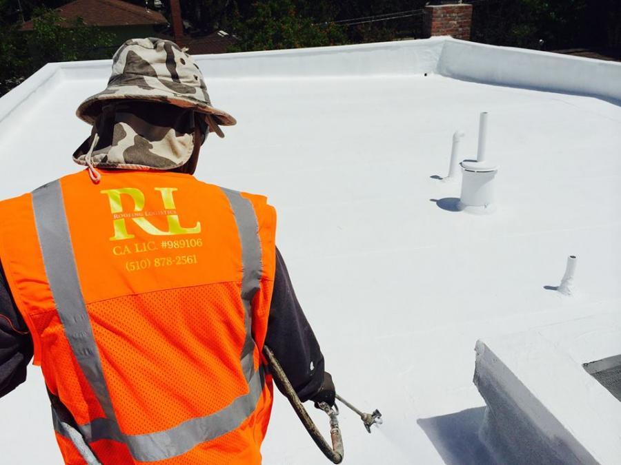Picture of A Roofing Logistics technician works on a client's roof. - Roofing Logistics, Inc.