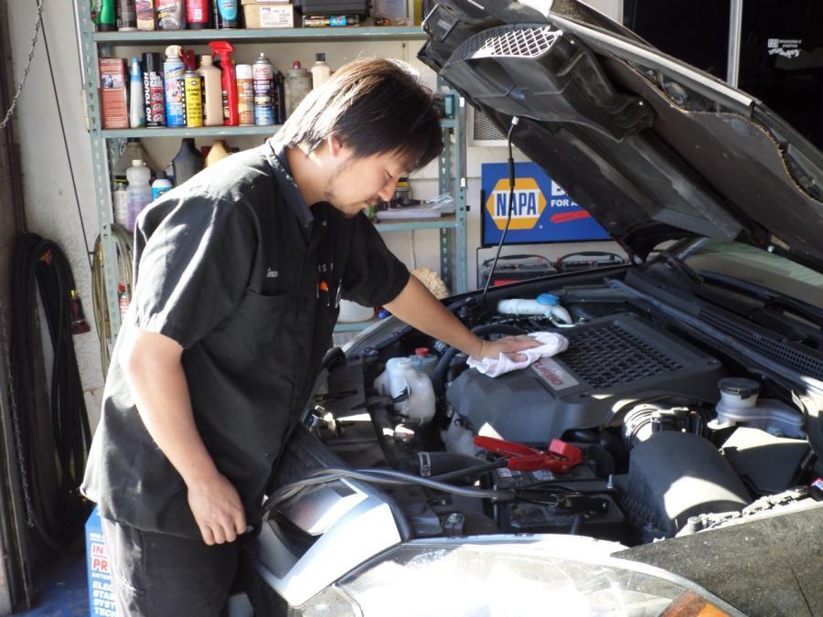 Picture of Co-owner Sean Gong prepares to work on a customer's engine. - T & S Auto Repair