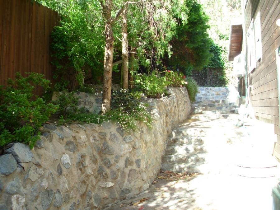 Picture of This down-slope lot is tiered with natural stone walls to create additional level space. - Thomas A Daly Construction