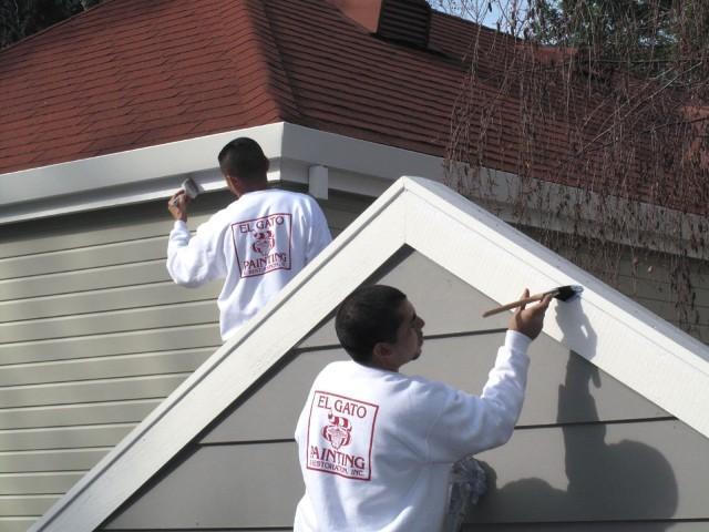 Picture of Two El Gato Painting & Restoration technicians paint a client's house. - El Gato Painting & Restoration, Inc.