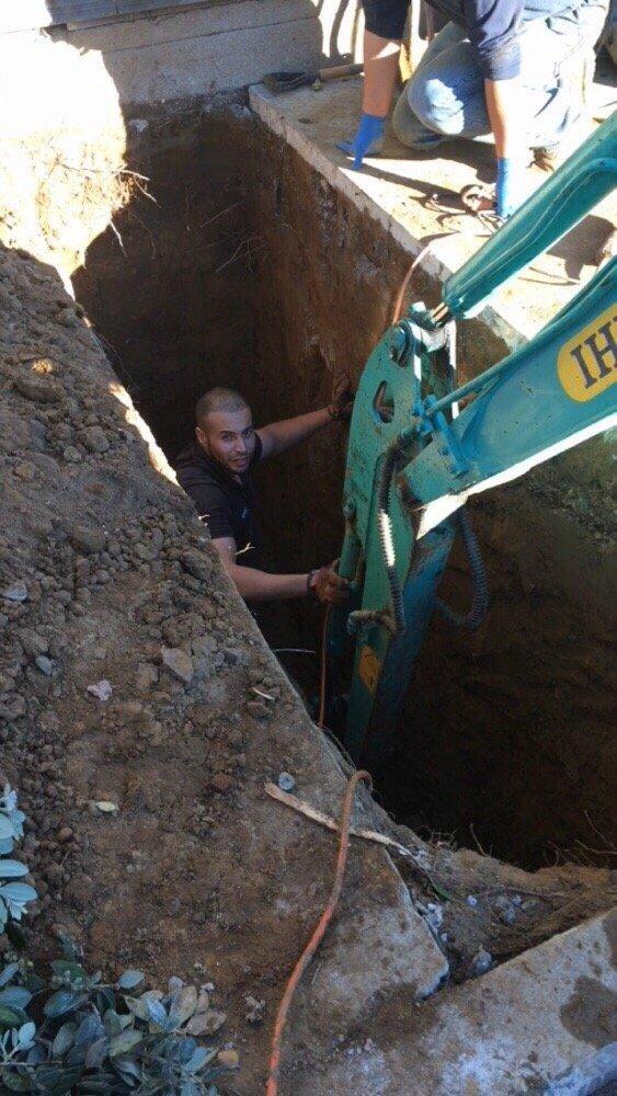Picture of A One Source Plumbing and Rooter technician works on a sewer line installation. - One Source Plumbing and Rooter, Inc.