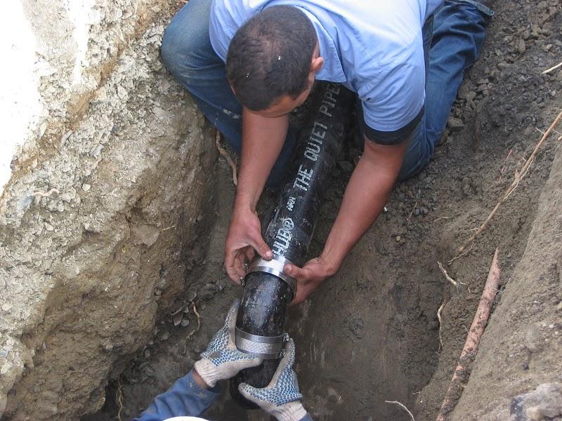 Picture of An Albert Nahman technician replaces a sewer pipe. - Albert Nahman Plumbing, Heating and Cooling