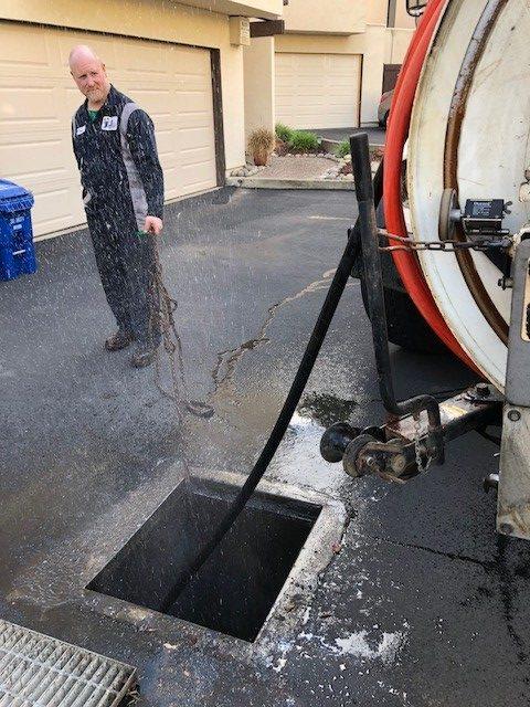 Picture of Absolute Plumbing and Drain's hydro truck works on a manhole. - Absolute Plumbing and Drain