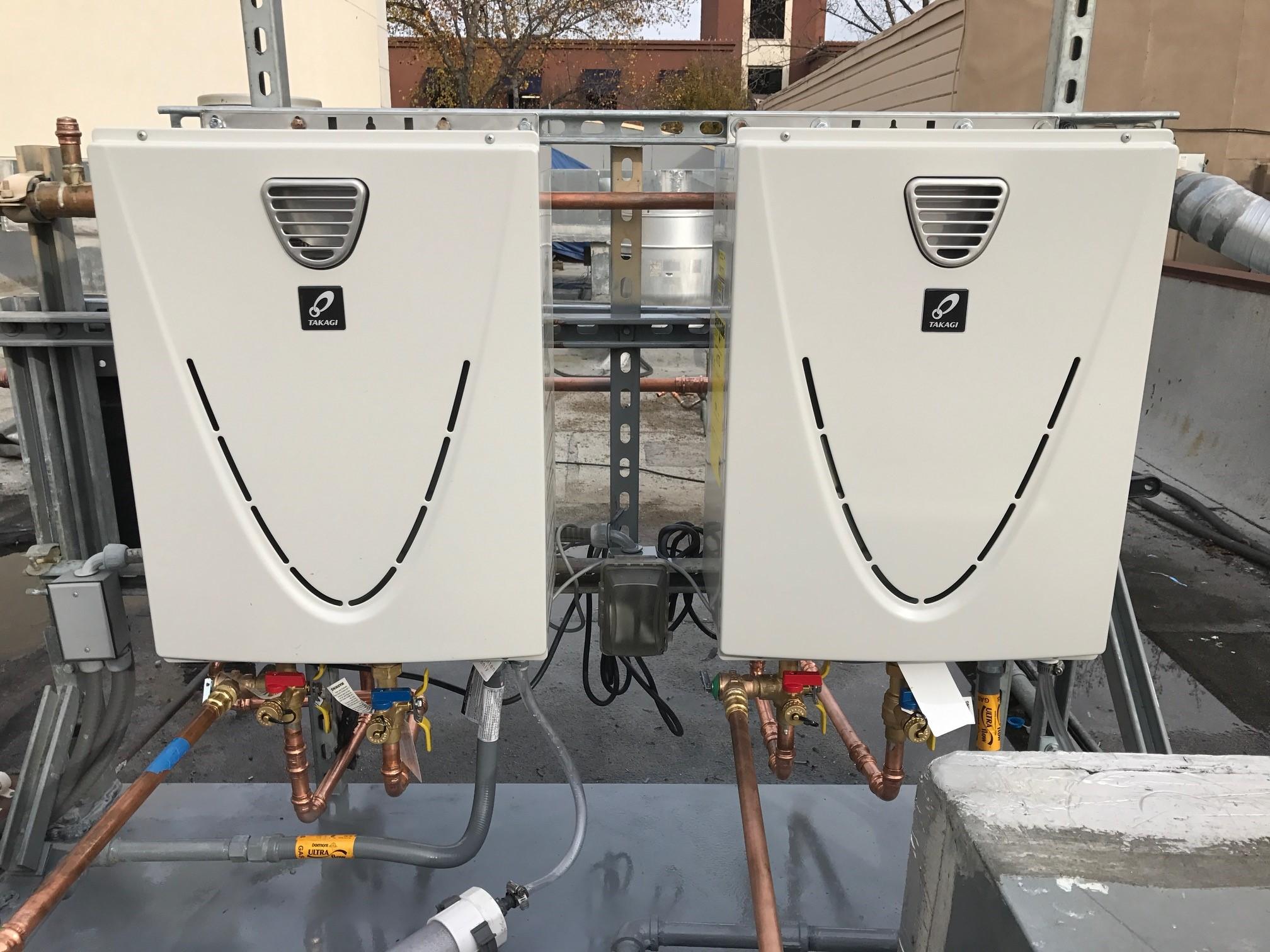 Picture of Absolute Plumbing and Drain installed this tankless water heater on a client's rooftop. - Absolute Plumbing and Drain