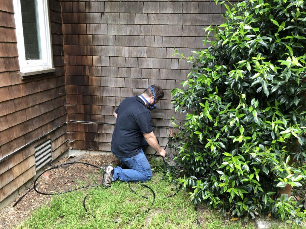 Picture of Co-owner Natan Framowitz cleans out a dryer exhaust vent. - FixEm Appliance Repair